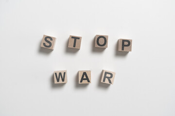 wooden cubes with stop war text on pastel background