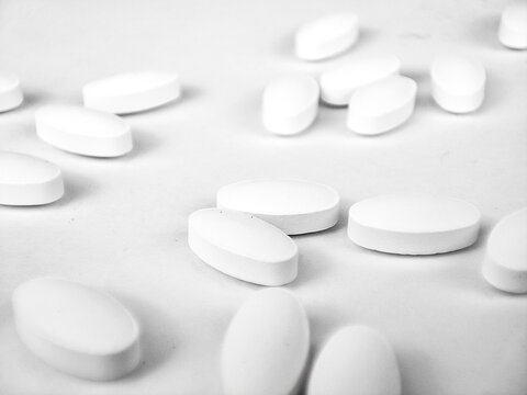 white pills on white background. white medical pills.