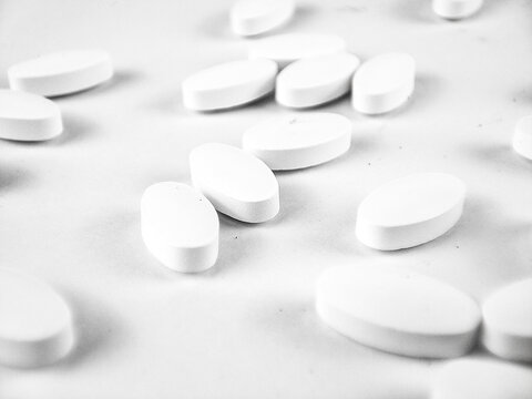 white pills on white background. white medical pills.
