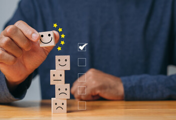Top Best excellent business services rating customer experience. Satisfaction survey concept. Hand of a businessman chooses a smiley face on wood block cube. 5 Star Satisfaction.