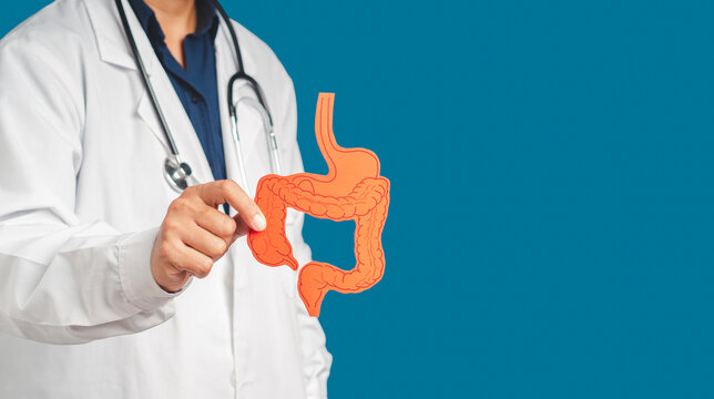 Hand of the doctor holding a colon symbol while standing on a blue background