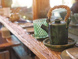 vintage craft tea pot on old wooden shelf.