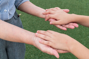 Grandmother holding her grandson's hand.