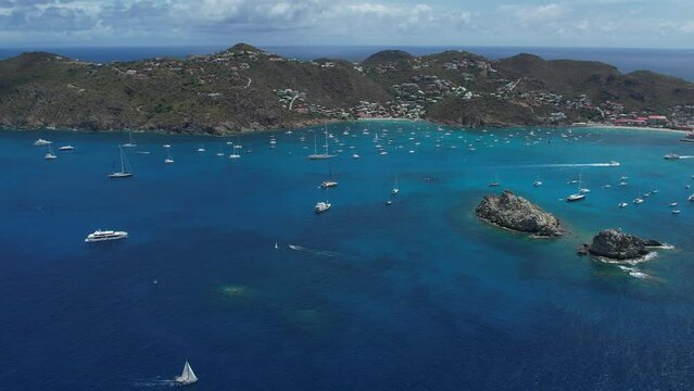 Drone Video Footage of Saint Barthelemy, Gustavia Regatta Sailboats racing in the sea with clear skies and calm waters near the coast with islands around beautiful and scenic 