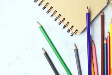 Wooden crayons scattered on the table, wooden rulers and notebooks with the festival back to the semester, students go to school, art lessons.