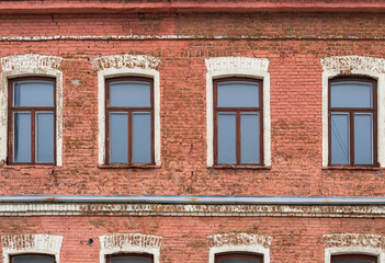Fototapeta na wymiar Four windows of the old mansion 19 century with brown bricks wall