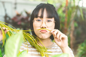 Young adult asian woman wear eyeglasses happy face mental therapy with nature environment