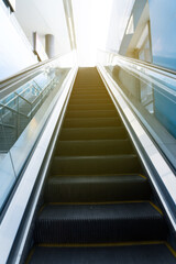 Mechanical escalator in modern subway train station at morning