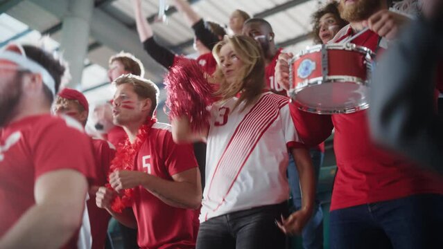 Sport Stadium Big Event: Crowd of Fans Cheer for Red Soccer Team to Win. People Celebrate Scoring a Goal, Championship Victory. Cute Caucasian Couple with Painted Faces Cheer, Shout.