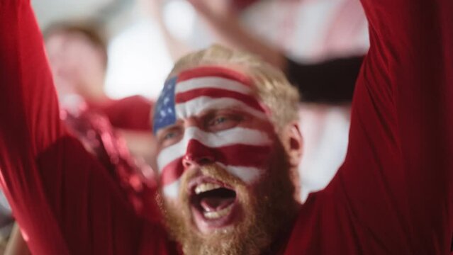 Sport Stadium Sport Event: Portrait of Handsome Man with U.S. Flag Painted Cheering for Red Americn Football Team to Win, Scream in Celebration of Victory. International Championship, World Tournament