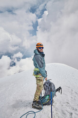 Climbing Kazbek, Georgia. male climber standing on the summit.  Nature of Caucasian mountains....