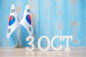 Wooden text of October 3rd with Republic of Korea flags. National Foundation Day, Gaecheonjeol,...