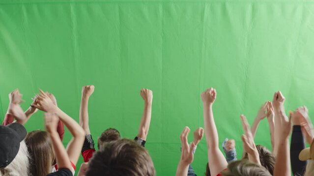 Green Screen Chroma Key Stadium Sports Event: Diverse Crowd of Fans Cheering, Shouting, Clapping, Applauding, Raising Hands Celebrating a Goal, a Win on a Big Soccer Championship. Back View Shot