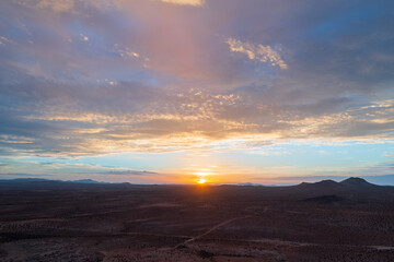 Naklejka na ściany i meble A beautiful clouded sunset over the Mojave desert. 