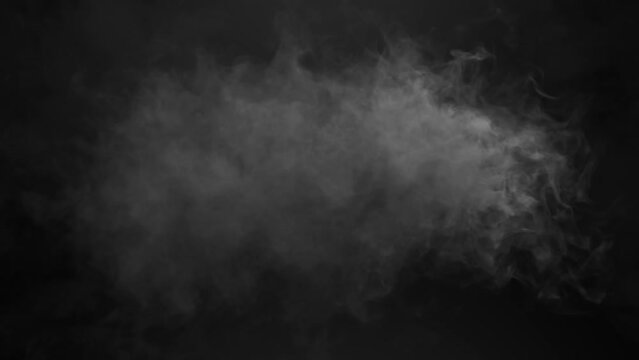 Animation of cloud of orange and grey smoke appearing and disappearing on black background