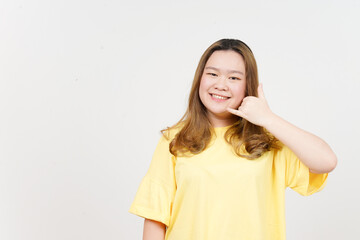 Fototapeta premium Call me back gesture of Beautiful Asian Woman wearing yellow T-Shirt Isolated On White Background