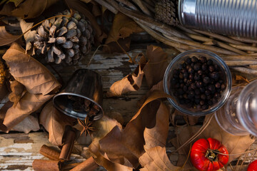Overhead view of leaves and pine cone on table