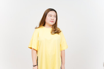 Fototapeta premium Looking aside of Beautiful Asian Woman wearing yellow T-Shirt Isolated On White Background