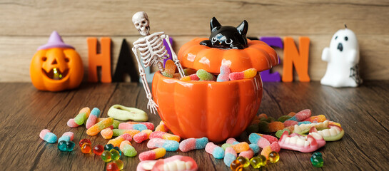 Happy Halloween day with ghost candies, candle, pumpkin, Jack O lantern and decorative (selective...