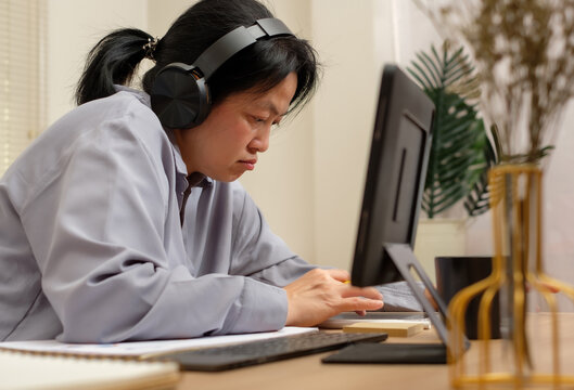 asian woman using tablet when take a break from video conference meeting - Powered by Adobe