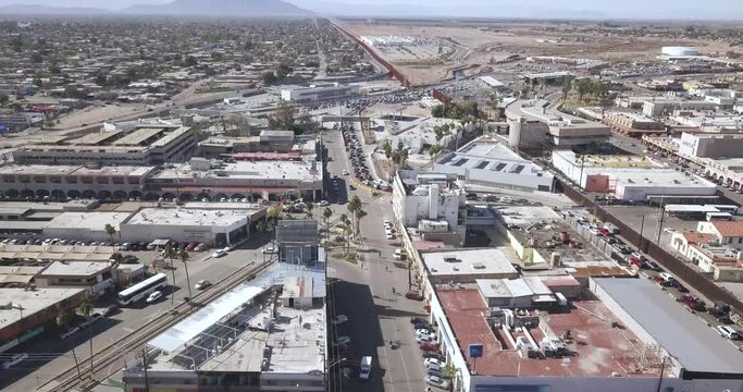 Drone ascending over Mexico aside the border of the United States of America