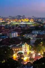 Fototapeta na wymiar Ancient fortress tower with Grand Palace at Dusk (Bangkok, Thailand)