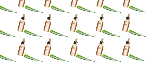 Many bottles of aloe vera essential oil on white background. Pattern for design