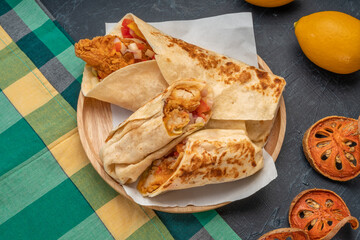 chicken and tomato in a tortilla wrap, Breakfast Wrap on wooden table background. 