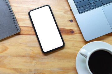 Top View Work space office desk, mockup empty screen smartphone on wooden table. with clipping path, with blank space screen for advertising text.