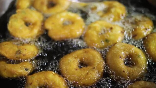 Uzhunnu vada or medu vada (uzhunnu vada is the malayalam name for medu vada) is a traditional Kerala style deep fried snack which is popularly served as a savory snack for evening Full HD Footage