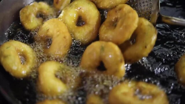 Uzhunnu vada or medu vada (uzhunnu vada is the malayalam name for medu vada) is a traditional Kerala style deep fried snack which is popularly served as a savory snack for evening Full HD Footage
