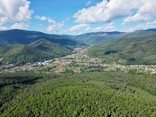 Fototapeta na wymiar Panoramic aerial drone view of Lautenbach, Schweighouse and the Florival valley on a sunny summer day