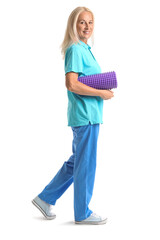 Mature physiotherapist with foam roller on white background