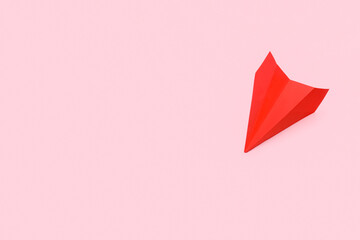 Red paper plane on pink background