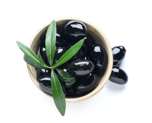 Bowl of black olives on white background