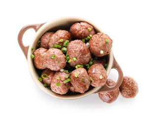 Cooking pot with tasty meat balls and cut green onion on white background