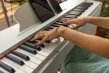 Female hands playing the electric piano, Hand and piano keys close up