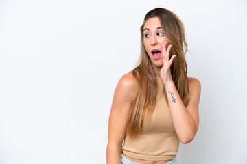 Young caucasian woman isolated on white background whispering something with surprise gesture while looking to the side