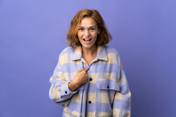 Young Georgian woman isolated on purple background with surprise facial expression