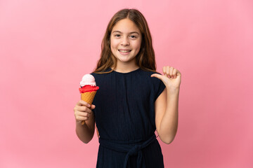 Child with a cornet ice cream over isolated pink background proud and self-satisfied