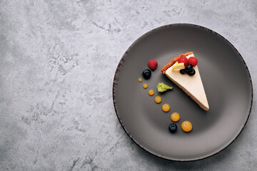 Cheesecake with berries, on a white concrete