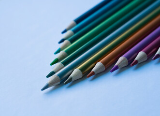 Colored pencils with a metallic sheen close-up. Background with place for text. High quality photo