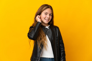 Child over isolated yellow background laughing