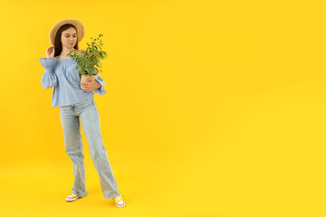 Concept of people, young woman on yellow background