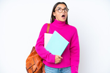 Young student woman isolated on white background looking up and with surprised expression