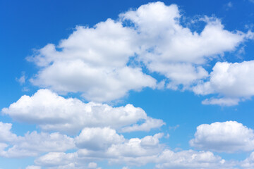 Fototapeta na wymiar Clear blue sky background with white clouds