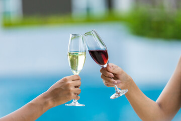 Cheers! People cheering with champagne . Wine Glasses Hitting Together at outdoor. Friend clinking glasses with champagne