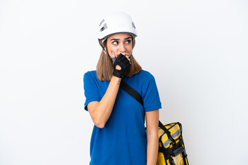Young caucasian woman with thermal backpack isolated on white background having doubts and with confuse face expression