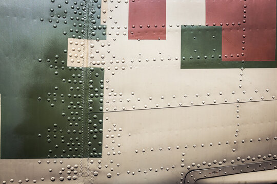 armor of helicopter, car, transporter, airplane, etc. with camouflage color rivets. Background