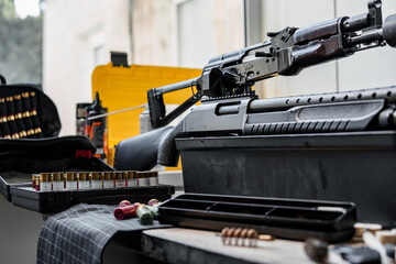 Shotgun rifle with cartridges on table in a weapon workshop